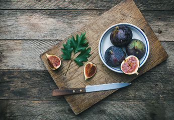 Image showing Cut Figs and knife on chopping board in rustic style