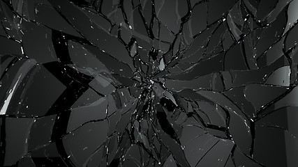 Image showing Pieces of broken and cracked glass on black