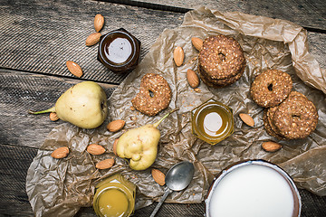 Image showing Tasty Pears almonds Cookies and cream on rustic wood