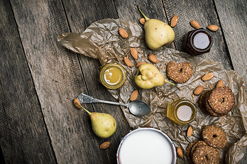 Image showing Pears nuts Cookies and joghurt on rustic wood