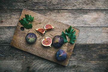 Image showing Ripe Figs on chopping board and wood