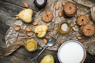 Image showing Tasty Pears nuts Cookies and joghurt on rustic wood