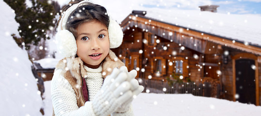 Image showing happy little girl wearing earmuffs