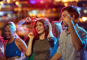 Image showing group of happy friends dancing in night club