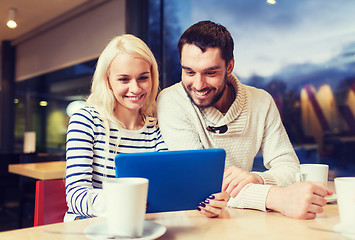 Image showing happy couple with tablet pc and coffee at cafe