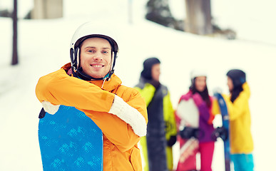 Image showing happy friends in helmets with snowboards