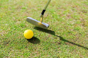 Image showing close up of club and ball near hole on golf field