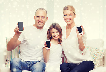 Image showing happy family showing smartphones blank screens