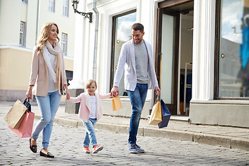 Image showing happy family with child and shopping bags in city