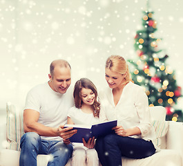 Image showing happy family with book at home