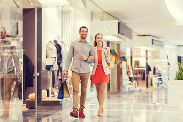 Image showing happy young couple with shopping bags in mall