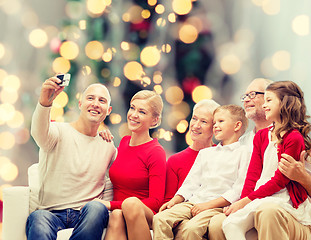 Image showing smiling family with camera