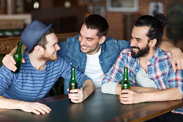 Image showing happy male friends drinking beer at bar or pub