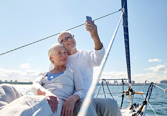 Image showing senior couple taking selfie by smartphone on yacht