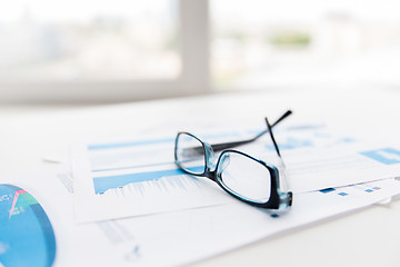 Image showing close up of eyeglasses and files on office table