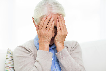 Image showing senior woman suffering from headache or grief