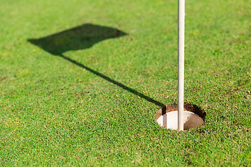 Image showing close up of flag mark in hole on golf field