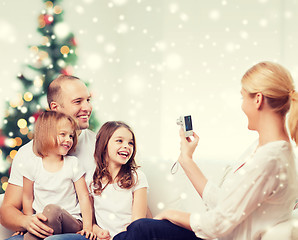 Image showing happy family with camera at home