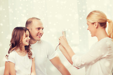 Image showing happy family with camera taking picture at home