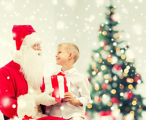 Image showing smiling little boy with santa claus and gifts