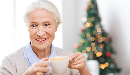 Image showing happy senior woman with cup of coffee at home