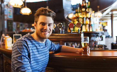 Image showing happy man drinking beer at bar or pub