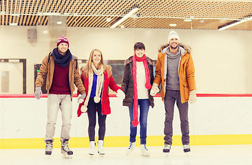 Image showing happy friends on skating rink