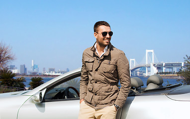 Image showing happy man near cabriolet car outdoors