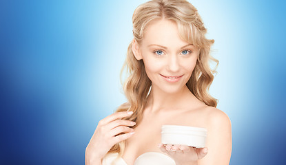 Image showing smiling woman cleaning face skin with cotton pad