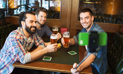 Image showing friends taking selfie and drinking beer at bar