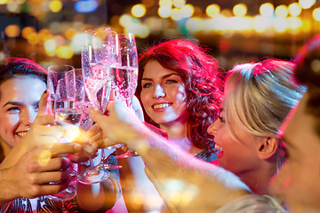 Image showing smiling friends with glasses of champagne in club