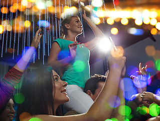 Image showing friends with smartphone taking picture at concert