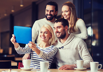 Image showing happy friends with tablet pc taking selfie at cafe