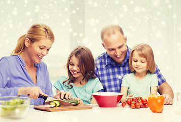 Image showing happy family with two kids making dinner at home