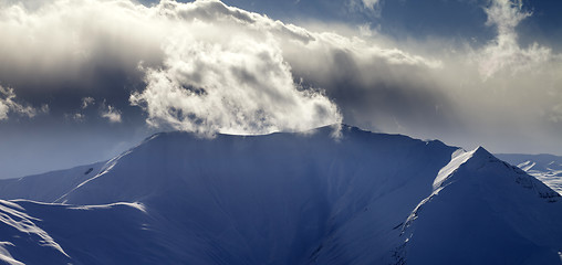 Image showing Panoramic view of mountains in sunset with sunlit clouds