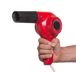 Image showing Old red hairdryer in hand