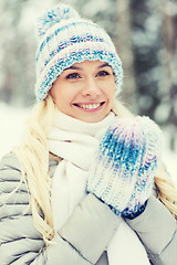 Image showing smiling young woman in winter forest