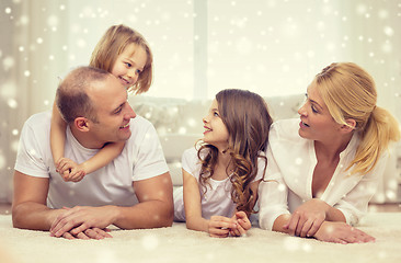 Image showing smiling parents and two little girls at home