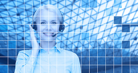 Image showing helpline operator in headset over blue grid