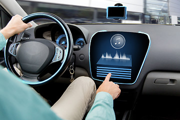 Image showing close up of man driving car with audio system