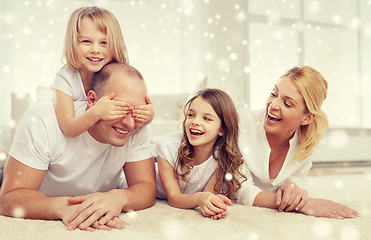 Image showing smiling parents and two little girls at home