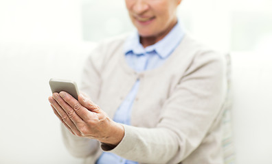 Image showing close up of senior woman with smartphone texting