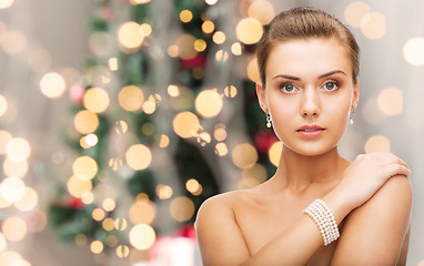 Image showing beautiful woman with pearl earrings and bracelet
