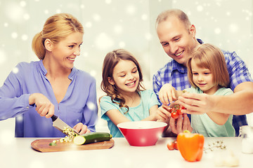 Image showing happy family with two kids making dinner at home