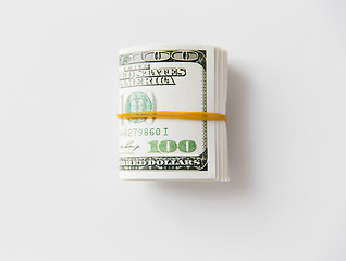 Image showing close uop of dollar money packet tied with rubber