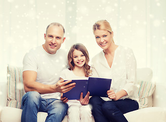 Image showing happy family with book at home