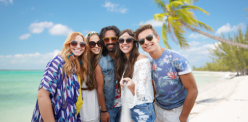 Image showing happy hippie friends with selfie stick on beach