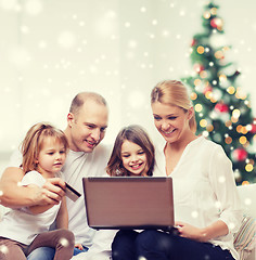 Image showing happy family with laptop and credit card at home