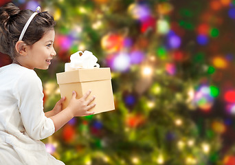 Image showing happy little girl with present over lights