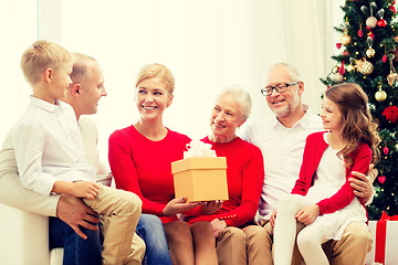 Image showing smiling family with gifts at home